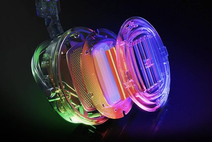 Oblique exploded view of a transparent plastic electronic enclosure, oval rings and grilles, multicolor RGB lighting