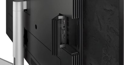 Телевізор Loewe Stellar 42 DR+ чорного кольору, вигляд ззаду зблизька з бічними роз’ємами та сріблястою підставкою
