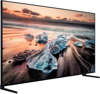 Samsung QE65Q900R-tv, der viser en strand ved solnedgang med isbelagte klipper i forgrunden