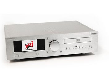 Block CVR-100+ MKIII all-in-one hi-fi system in brushed aluminum silver, three-quarter front view, featuring a large color display, a wide central dial, a CD slot, and a row of buttons and ports on the front panel