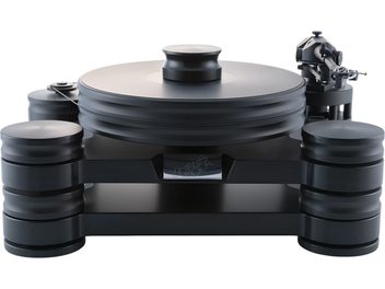 Transrotor Dark Star Reference RB880 matte black solid composite hi-fi turntable, front view from a slight overhead angle, featuring a thick circular platter with central record clamp, left-side belt, tonearm on the right, and three large stacked cylindrical feet providing support
