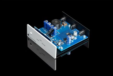 Roksan Caspian phono preamplifier with silver faceplate and blue circuit board seen in perspective on black background