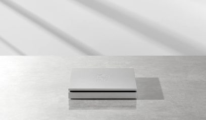 Brushed metal Rose RSA780 CD player, front angled view on a solid gray background, logo engraved on the lid