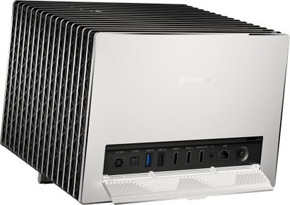 Valerion StreamMaster Plus 2 matte white video projector in metal and plastic with a large black finned side heatsink and a rear panel featuring multiple ports protected by a folding cover, three-quarter rear view