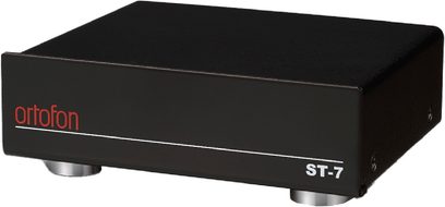 Transformator voor platenspeler Ortofon ST-7, driekwart zicht, zwarte behuizing, metalen voetjes, rood logo, witte tekst