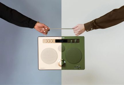 Bærbar tofarvet radio i beige og grøn plast, med to højttalere, knapper og skyder, metalhåndtag, set forfra