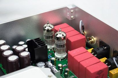 Nærbillede af indersiden af en Jolida JD100 MKII CD-afspiller med vakuumrør, røde kondensatorer og elektroniske komponenter
