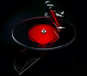 Transparent circular platter with a red disc at the center, red angular arm with a white tip, black background