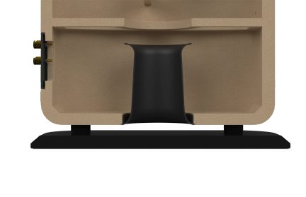 Beige bathroom sink viewed from below with black central overflow and gold side fittings