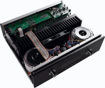 Top-down angled view of the black Primare SPA 21 hi-fi stereo amplifier with the lid open, revealing the internal components