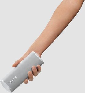 Sonos Roam Lunar White Bluetooth speaker held in a hand against a white background, side view