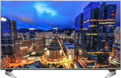 Panasonic TX-58DX700F-fladskærm, der viser en natvisning af oplyste skyskrabere i en stor asiatisk by