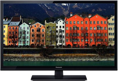 Panasonic TX-L32XM6 fladskærms-TV, der viser et billede af farverige bygninger ved vandet med bjerge i baggrunden