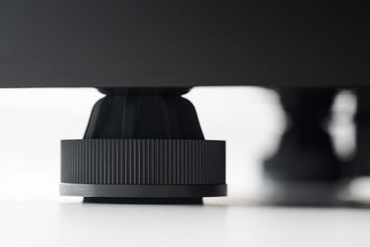 Pro-Ject Juke Box E sort lakeret pladespiller. Nærbillede, forfra. Låget er lukket, knapper og tonearmen er synlige