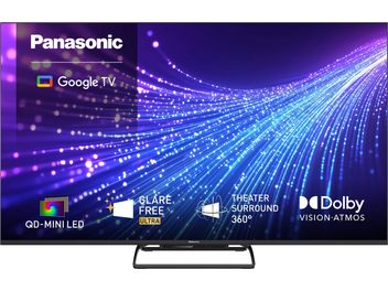 Panasonic TN-65W95C-TV med smale rammer på svart sokkel, lilla og blå skjerm med Google TV-logo