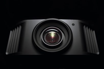 JVC DLA-NZ9 black projector, front view, centered lens surrounded by side grilles, on a solid black background