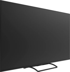 Svart Panasonic TN-86W95C-TV med avslått skjerm, smale kanter og åpen midtfot, sett på skrå forfra