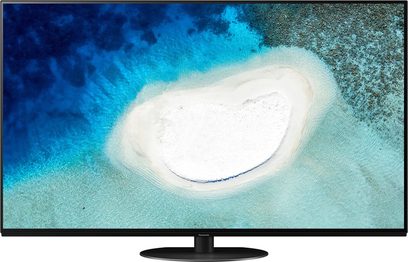Panasonic TX-65HZ1000E 65" fladskærms-TV, OLED-skærm der viser et luftfoto af en hvid sandbanke omgivet af turkisblåt vand