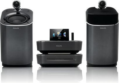 Philips MCI900 sølvfarvet hi-fi minianlæg bestående af to cylindriske højttalere og en central enhed med skærm, set forfra