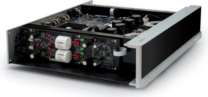 Matrix Audio MS‑1 nettverksspiller i sølvfarget aluminium med blank svart front, sett i trekvart vinkel forfra til høyre med lokket fjernet, som viser svarte kretskort, svarte sylindriske kondensatorer og to store hvite kondensatorer