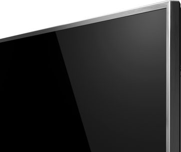 Panasonic TX-75FX780 fladskærms-TV set fra siden, skærm slukket, smal sølvfarvet ramme, mat sort bagside