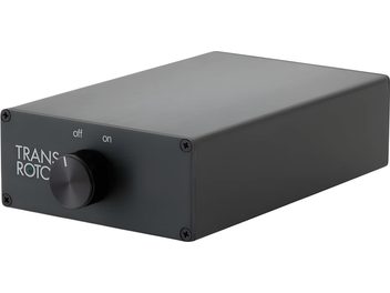 Transrotor Phono Studio phono preamp in black brushed aluminum, compact rectangular case seen from the front right three-quarter view, with a front panel featuring a central black rotary knob, green LED, and four corner screws