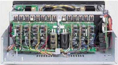 Interior view of an open Onkyo PR-SC886 amplifier, revealing numerous electronic components and colorful cables