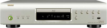 Denon DBP-2011UD sølvfarvet Blu-ray-afspiller, set forfra, blåt digitalt display, knapper og stik på forsiden