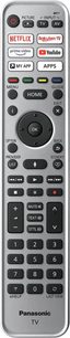 Grå Panasonic fjernbetjening med sorte og hvide knapper til TV-funktioner, apps og navigation, set forfra