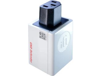 iFi Audio GND Defender power conditioner, rectangular white plastic housing with raised circular logo, QR code, and red lettering on the side, topped with a three-slot black female plug, perspective view