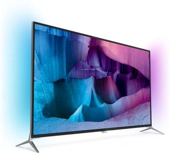 Philips 49PUS7100 tv set forfra, slukket skærm der viser abstrakte blå og lilla former på sort baggrund