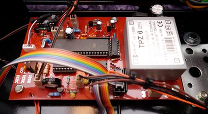 AudioValve Assistent 50 black hi-fi stereo amplifier, interior view of multicolored electronic components and printed circuit boards