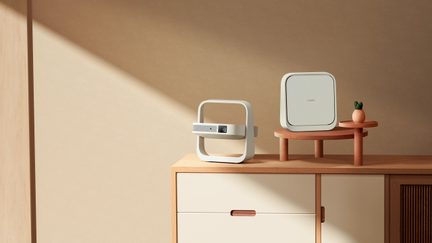 XGIMI projector and white square box on wooden furniture, minimalist beige interior decor