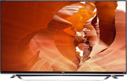 LG 65UF850V TV set i 3/4 bagfra, flad orange skærm med bølgende mønstre, smal sølvfarvet ramme