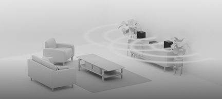 Draadloos audiosysteem met zwarte luidsprekers die surroundgeluid verspreiden in een moderne, minimalistische woonkamer