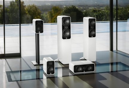 Set of five rectangular hi-fi speakers with a white lacquered finish, black fronts featuring visible circular drivers, and a metal stand, front view