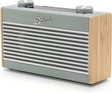 Blå ankafärgad bordradio Roberts Rambler Uno, front med horisontell metallgaller, ljust trä på sidorna, två stora grå cirkulära knappar på ovansidan, vy från höger framifrån i trekvartsprofil