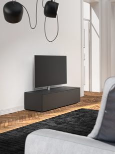 Czarna, matowa niska szafka TV Spectral Next NXS1600-BG, 2 szuflady, widok lekko z góry w nowoczesnym wnętrzu