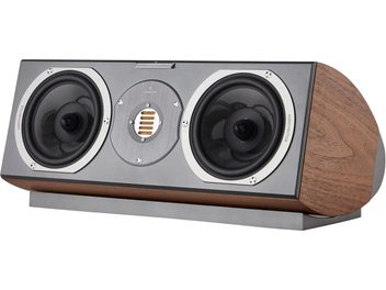 AudioVector R Center Arreté walnut center speaker, three-quarter front right view, cabinet in veined brown walnut veneer with rounded sides, matte gray front panel featuring two black mid-bass drivers with aluminum rings and a central gold ribbon tweeter, resting on a matching gray base