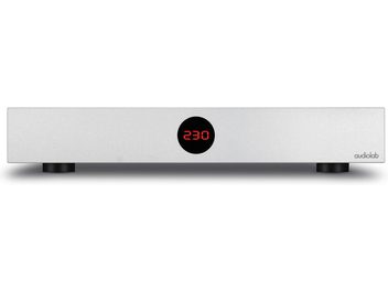 Conditionator de rețea Audiolab DC-BLOCK 6 argintiu cu afișaj digital roșu "230" în centru și picioare circulare negre
