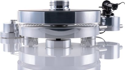 Платівка для вінілових платівок Transrotor Max RB330 сріблястого кольору з полірованого металу та акрилу з циліндричними накладеними плато, вид спереду, що демонструє товсте основне плато, блискучий центральний підшипник та бічний тонарм