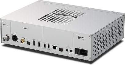 Transport numérique Matrix Audio NT‑1 argenté en aluminium brossé, vue trois‑quarts arrière gauche, dessus perforé en motif S et flancs latéraux ventilés, panneau arrière présentant connecteurs BNC, XLR, RCA, optiques, USB, HDMI I²S, LAN, triggers et prise secteur IEC