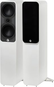 Pair of Q Acoustics 5050 matte white floorstanding speakers in composite with metal bases, three-quarter front view showing two conical drivers and a tweeter on a black baffle on one speaker, while the other features a black acoustic grille