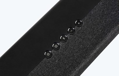Denon DHT-S217 sort soundbar, nærbillede af en del, 5 runde knapper på toppen, vævet stof dækker forsiden