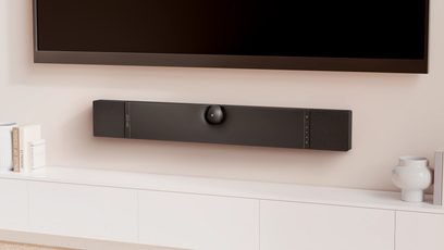 Саундбар DEVIALET DIONE черен, преден изглед, монтиран на стената под телевизор в модерен салон