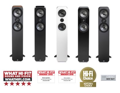 Five black acoustic speakers of varying sizes, aligned from smallest to largest, with logos and awards displayed