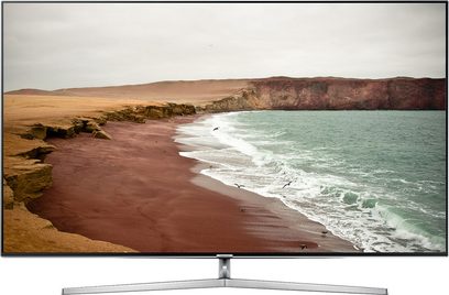 Samsung UE65KS8000 tv der viser en øde strand, smal sølvfarvet ramme, centralt metalstativ, set forfra