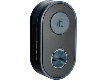 iFi Audio UP Travel wireless transmitter in midnight blue with a matte plastic finish, featuring an oblong case with rounded corners shown in a three-quarter front view, with a raised logo disc on top and a grooved circular knob at the bottom
