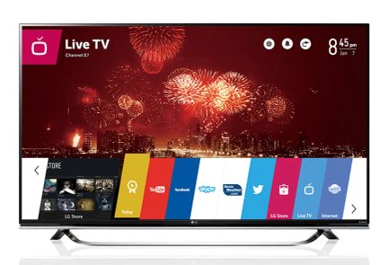 Tv-skærm, der viser en brugergrænseflade med apps og et rødt fyrværkeri over en by om natten