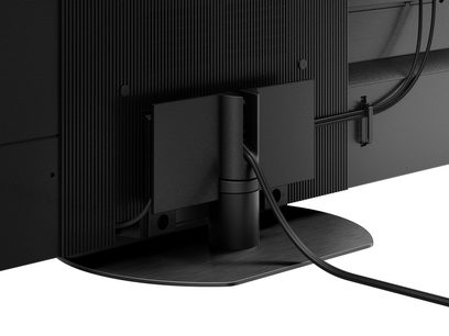 Téléviseur Panasonic TX-65MZ2000E, vue arrière, connectique, câbles branchés, pied central noir mat, écran noir